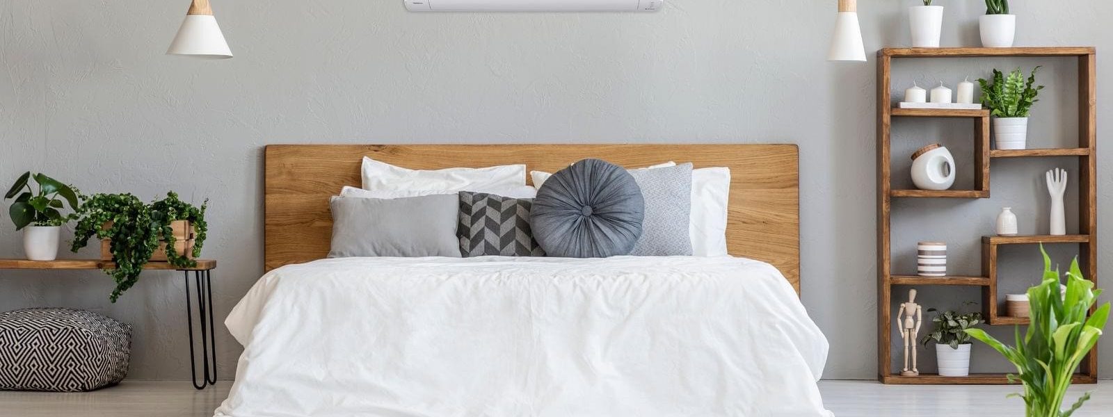Panasonic wall-mounted heat pump above the bed in a bedroom